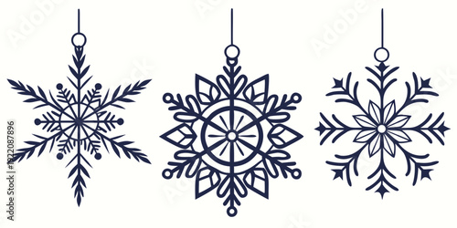 Three intricately designed snowflakes hanging from strings