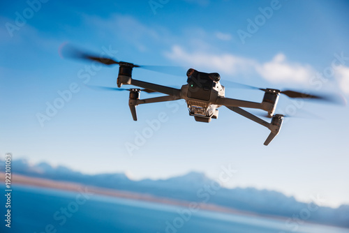 Drone flying under blue sky