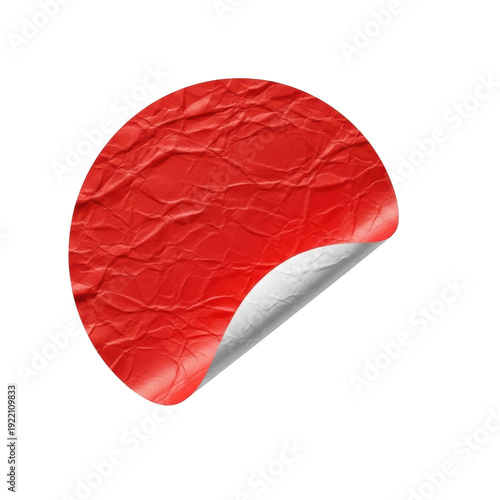 Red round paper sticker with crumpled, wrinkled texture, lower left edge peeled to reveal white adhesive, isolated on a transparent background. Product photography concept