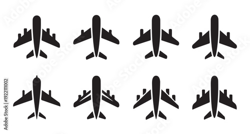 Set of eight black airplane silhouettes with different wing and tail designs isolated