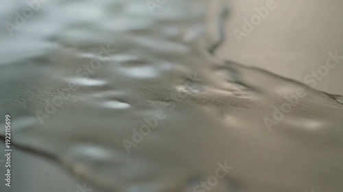 Subtle Fluid Dynamics Highlight the slow, almost imperceptible movement of the liquid.