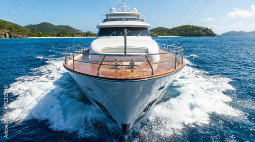 View from luxury yacht bow cruising tropical ocean towards islands.