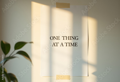 Motivational quote one thing at a time taped to wall