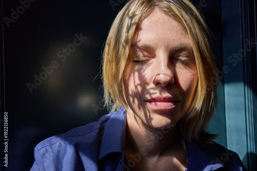 Woman soaking up window sun 