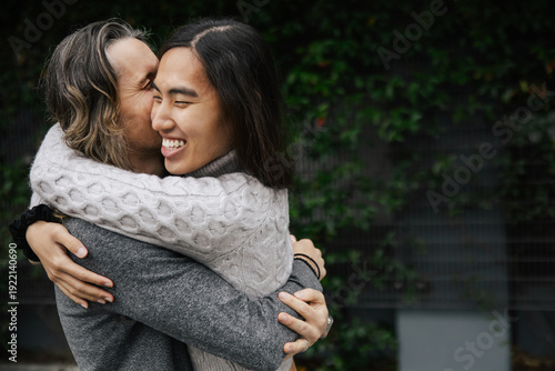 Two Individuals Sharing a Warm Hug in an Outdoor Setting