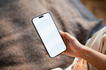 A white-screen mobile phone in a woman's hand