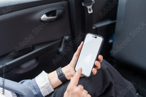 Businesswoman using smartphone with blank white screen 