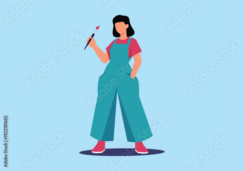 Female Artist Holding Paintbrush and Wearing Overalls