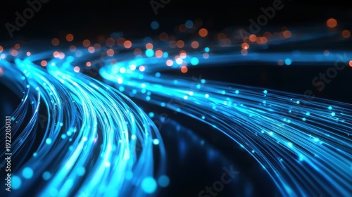 Fiber cable curves creating abstract blue light pathways through dark background with streaming optical data transmission trails