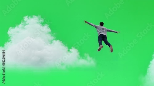 Wallpaper Mural Man falling through clouds on green screen background. Torontodigital.ca