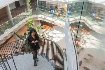 Woman Walking On Spiral Staircase