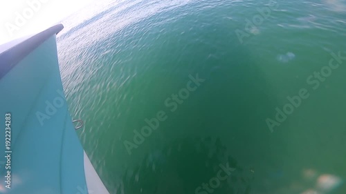 Motorboat fast floating on smooth sea surface of water to shore on sunny summer day. Blue sea and sky. Vacation travel tourism. Summer travel view landscape. View from bow of boat. Sea background.