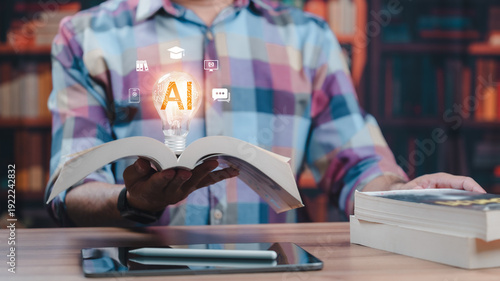 фотографія Student holding open book displays glowing AI lightbulb hologram representing sm