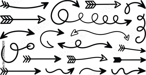 Set of hand drawn doodle arrows including curved swish spiral and feathered tribal styles isolated on white background black pointers.