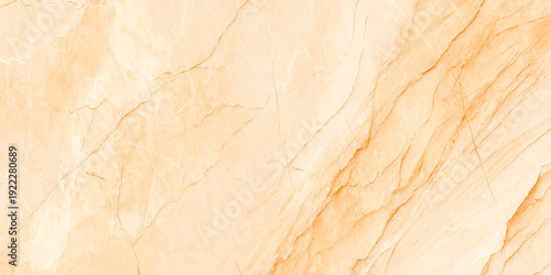 A close up view of a light peach and gold colored marble texture with natural veining patterns