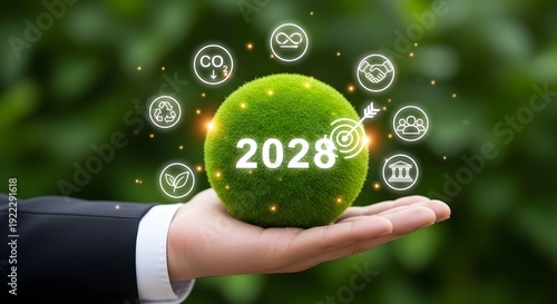 A businessperson holding a moss-covered ball symbolizing sustainability and 2028 goals