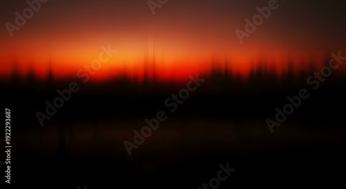 Vibrant orange sunset over a silhouette landscape