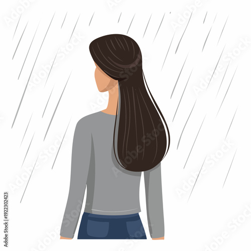 A young woman standing alone in the rain viewed from behind