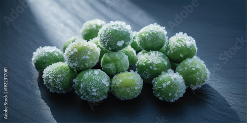 Green peas covered with salt crystals on dark surface