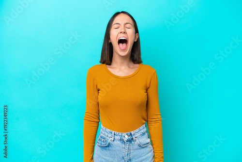 Young caucasian woman isolated on blue background with neckache