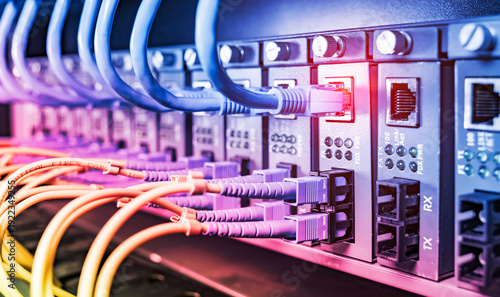 Obraz na płótnie Fiber Optic cables connected to optic ports and UTP, Network cables connected to ethernet ports