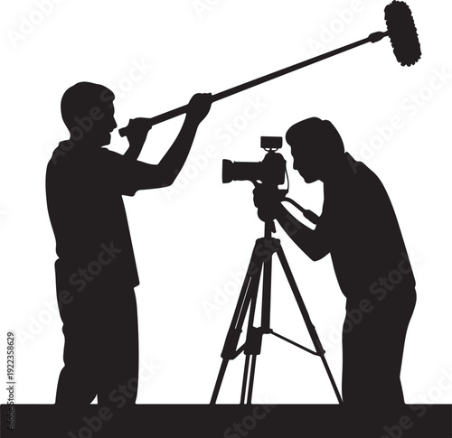 Silhouette of Cameraman and Boom Operator Filming a Scene
