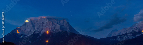 Konstfotografi Mountain peaks illuminated by traditional solstice fires in the Austrian Alps at