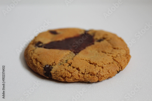 One chocolate soft cookie, melted chocolate, isolated on white background