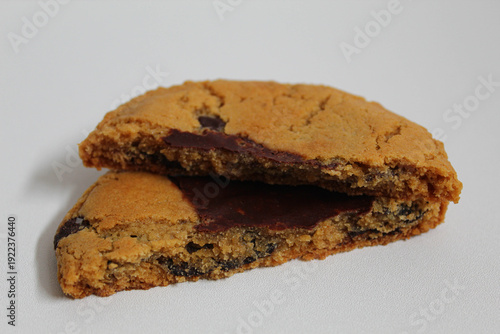One chocolate soft cookie, melted chocolate, isolated on white background