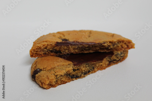 One chocolate soft cookie, melted chocolate, isolated on white background