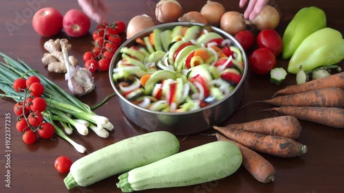 Fast Rotation move Vegan french tian 4K. Traditional French vegetable seasonal ratatouille casserole. Harvest festival autumn dish. Onions zucchini, eggplant, tomatoes, peppers arranged circle