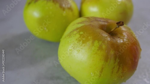 Ripe Tree green Apples on grey background. Production concentrate, puree, cider. Fresh autumn smell. Agricultural products. Juicy concept 4K, 2026