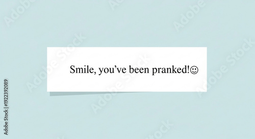 Funny prank sign with smiling emoticon on light blue background saying you've been pranked