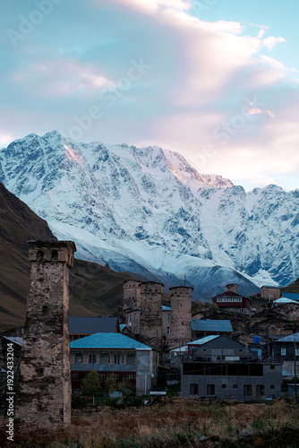 Majestic Shkhara Snow Mountain with Medieval Towers in Ushguli Village, Svaneti Georgia at Sunset, Autumn Landscape