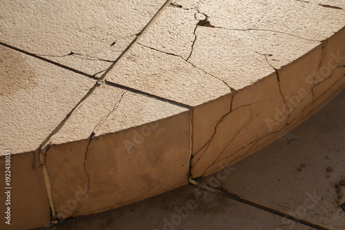 Cracked concrete surface with erosion in sunlight infrastructure repair maintenance concept