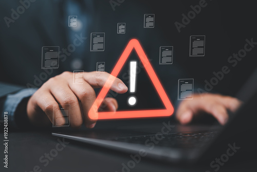 Tableau sur toile Close-up of person pointing at personal data and documents with warning sign, symbolizing data breach, cyberattack, hacker intrusion, spyware risk, and digital security protection concept