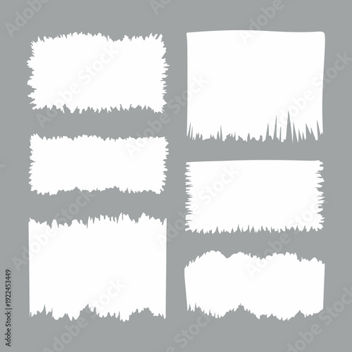 Roughly textured white frames with uneven edges arranged in a grid on a plain gray background