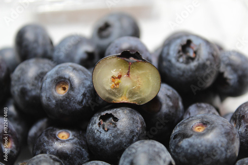 Cross section blueberry among the whole fruits, isolated on white background