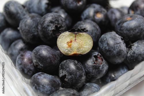 Cross section blueberry among the whole fruits, isolated on white background