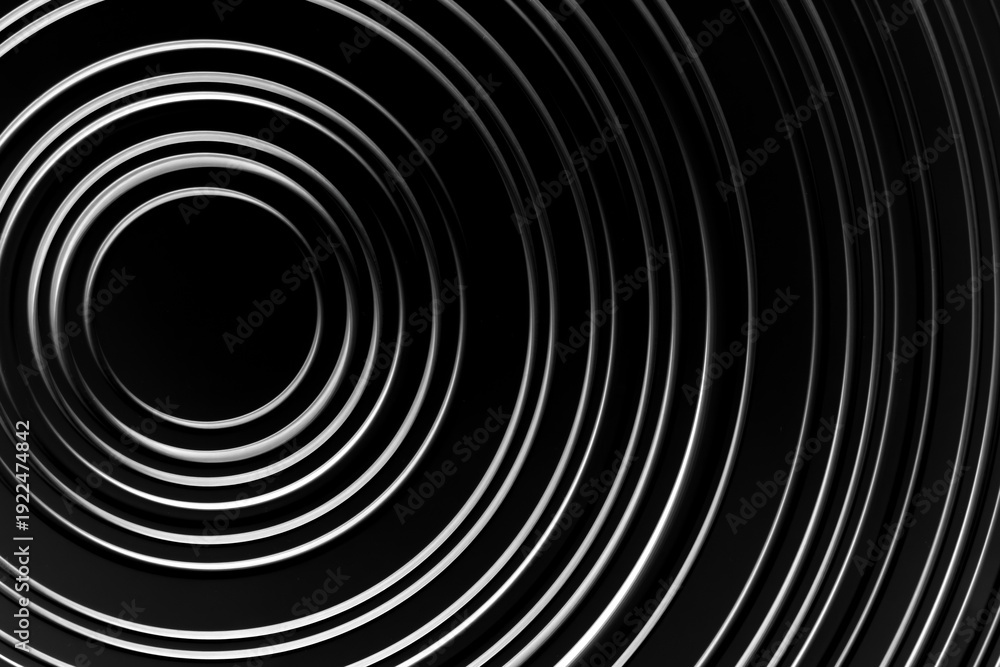 Obraz premium image is white circle on black background. circle is surrounded by series of smaller circles, creating sense of depth and movement