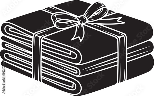 Stacked folded fabrics tied with ribbon bow representing laundry service or gift package of fresh clean textile linens