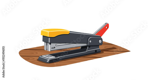 A black stapler with a prominent yellow plastic top is positioned on a light wooden surface.