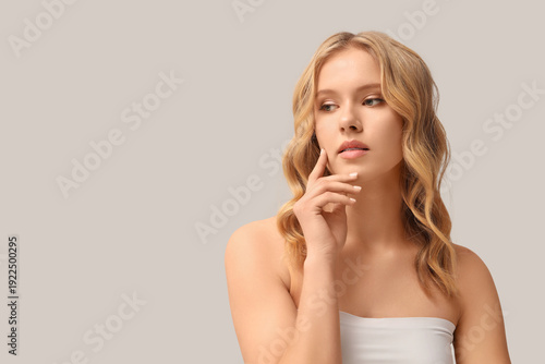 Blonde young woman with cur...
