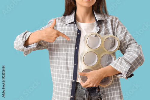 Young woman pointing at adh...