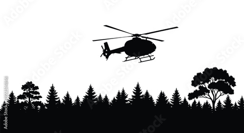 A helicopter flies over a forest depicted in dark silhouette