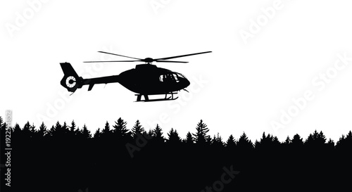 A helicopter flies over a forest in stark black silhouette