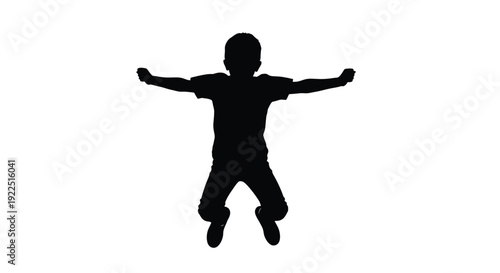 A joyful child with arms outstretched captured in a dark silhouette