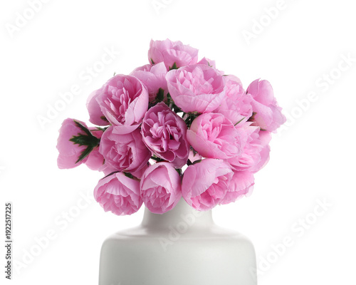 Vase with artificial pink flowers on white background, closeup