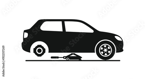 Black silhouette of a car being jacked up for repair silhouette