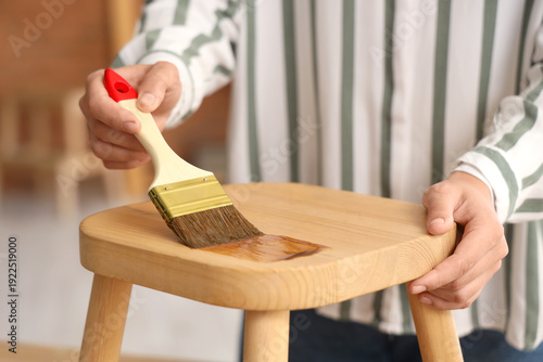Woman painting garden stool...